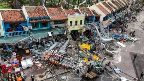 Getty Images Damaged buildings and debris on a street after super typhoon Yagi hit Ha Long, in Quang Ninh province